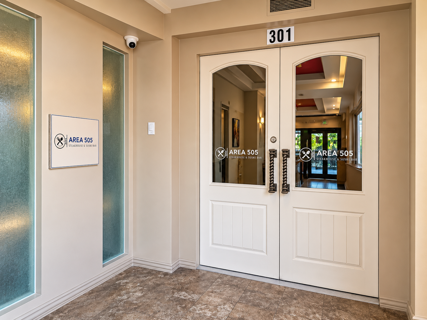 Entrance of the AREA 505 Sushi Bar at suite 301, with the restaurant's logo on the glass double doors