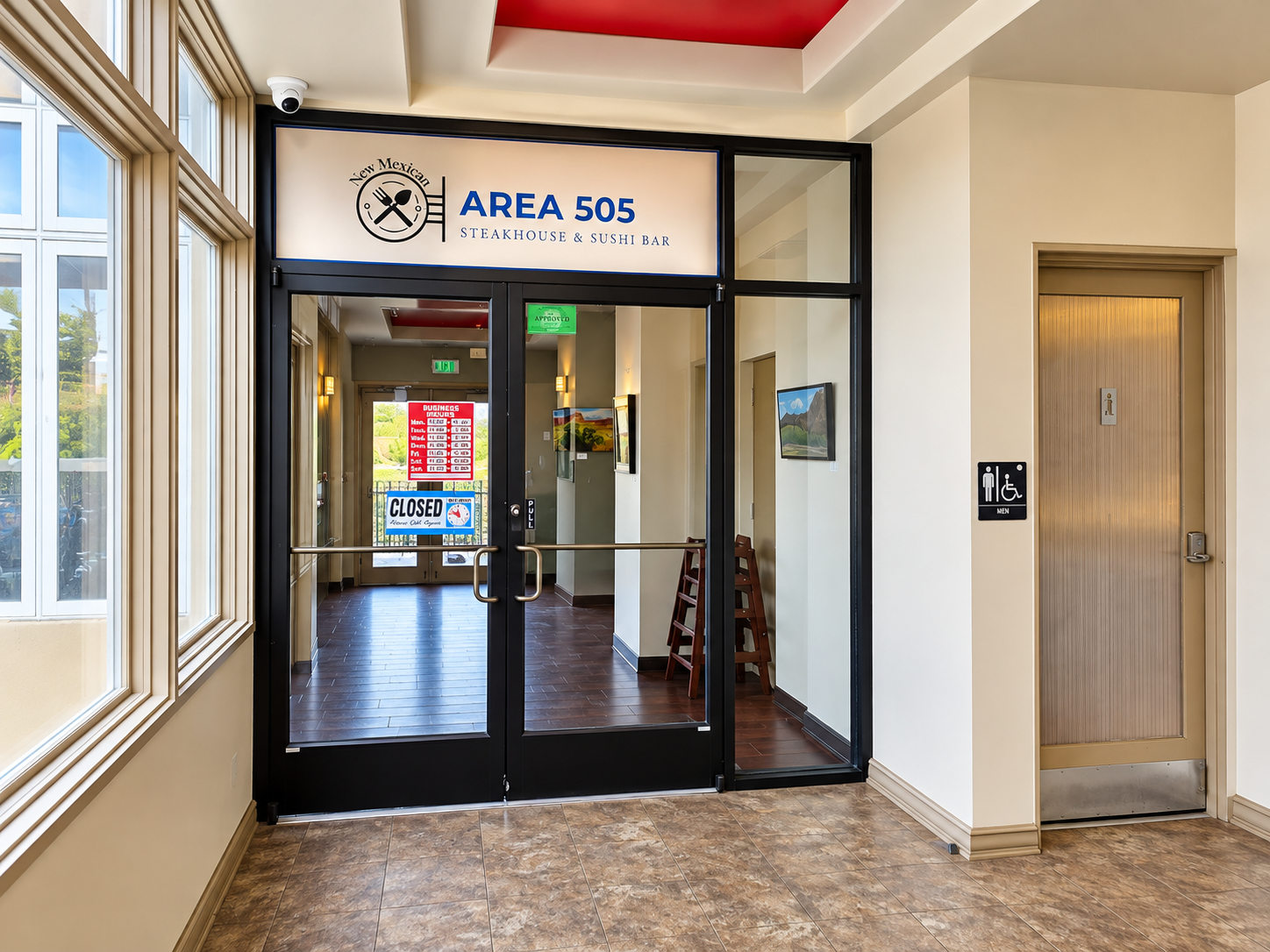 Entrance of AREA 505 in Santa Fe with the restaurant's logo above glass double doors